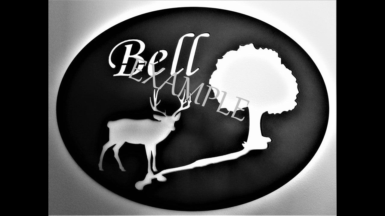 Custom black metal silhouette featuring a buck with tree and river with the last name Bell. 16 inches by 14 inches priced at 60 dollars. Customizable contact us 231-299-7610