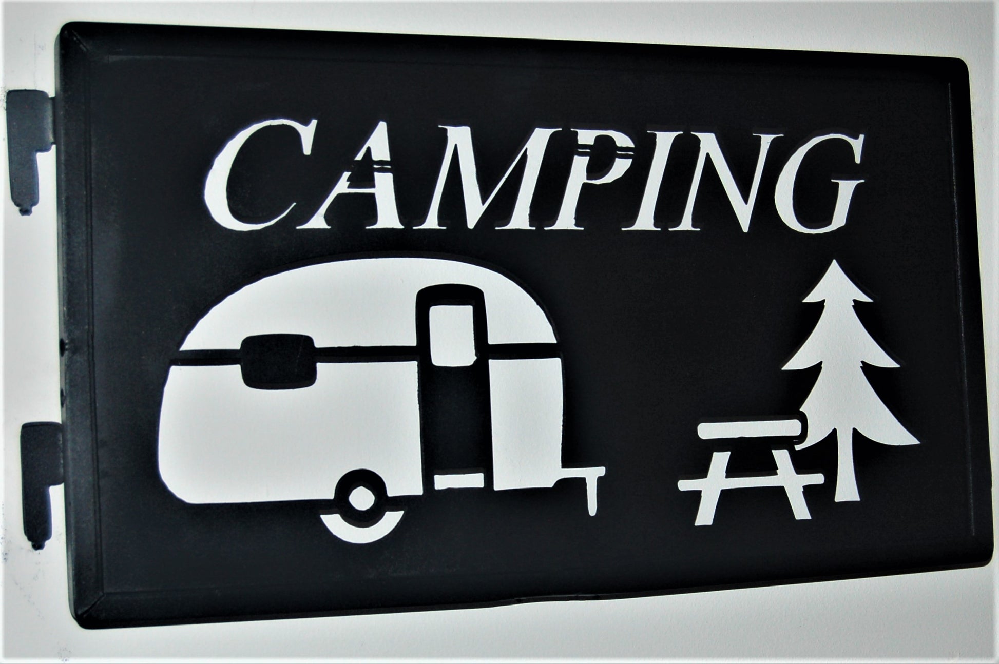 black metal Camping inspiring panel featuring camper, picnic table and pine tree