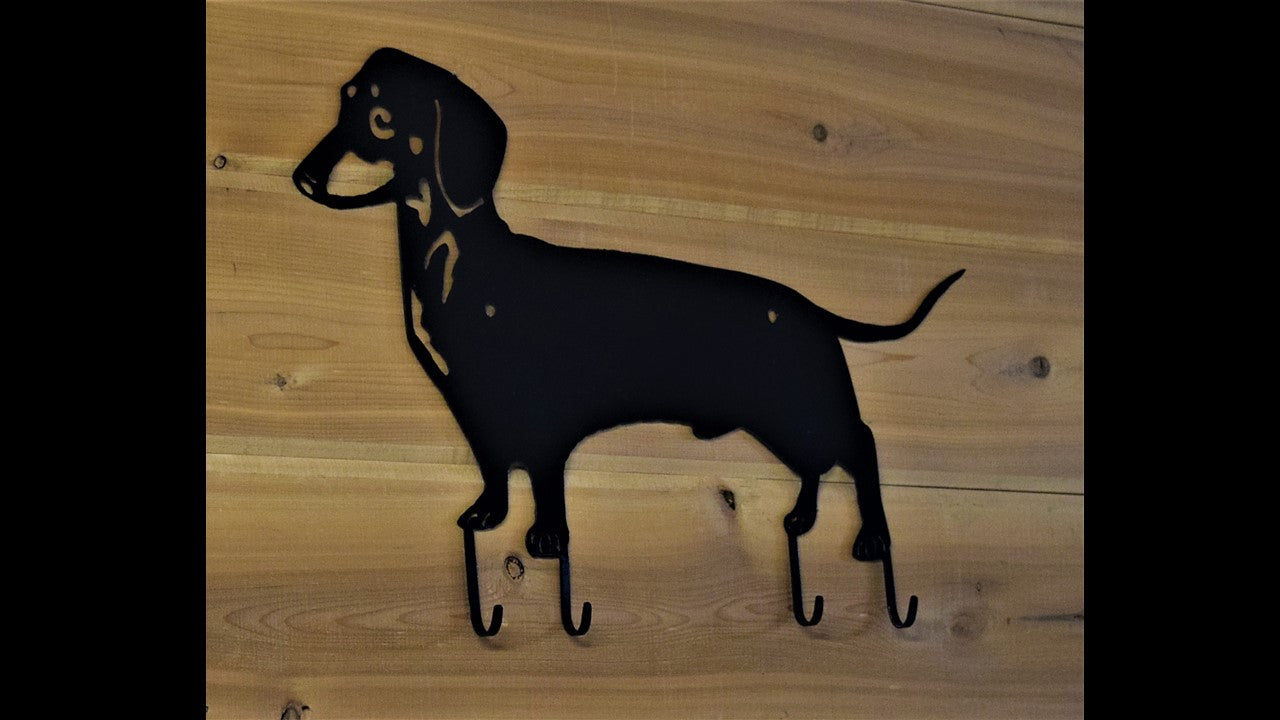 Black metal custom dachshund key hook with 4 metal hooks. 18 inches long by 11 inches tall. Priced at 20 dollars SKU number DHKH