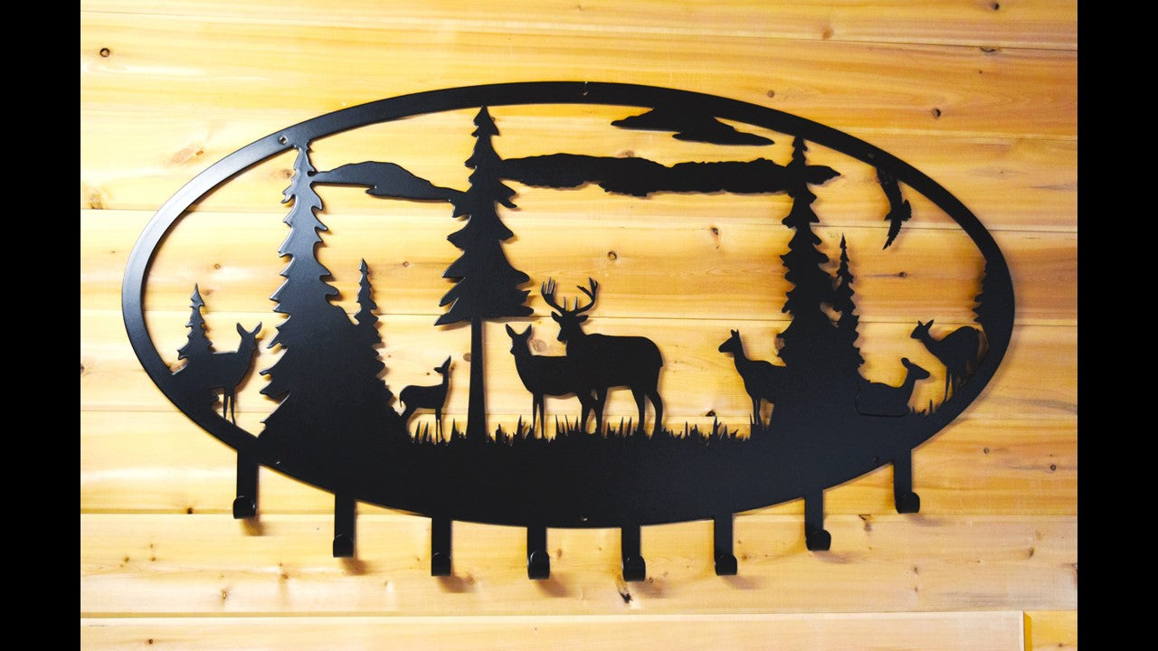 black metal extra Large coat and hat rack deer scene with 8 hooks. Includes 7 deer an eagle 6 pine trees and clouds. 48 inches wide by 24 inches tall. Priced at 220 dollars. 
