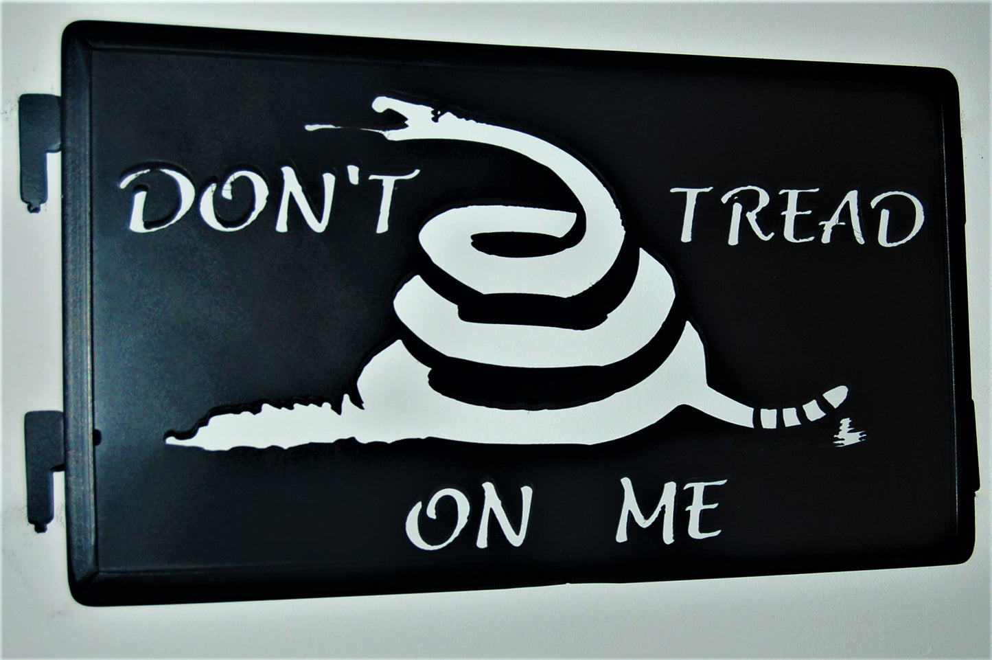 Black metal Don't tread on me inspiring panel with snake coiled in the center 