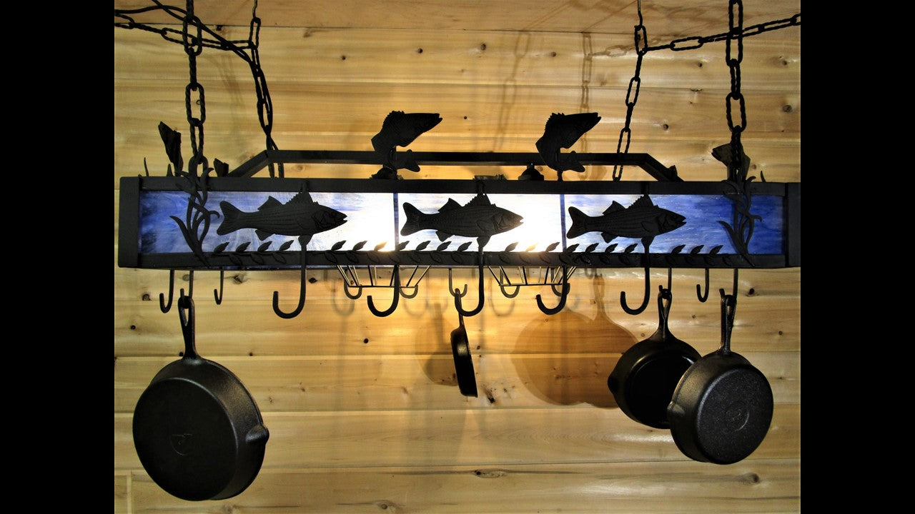 Black metal decorative hanging pot rack with dimensional fish design and back lighted stained glass. Priced at 1,899.00