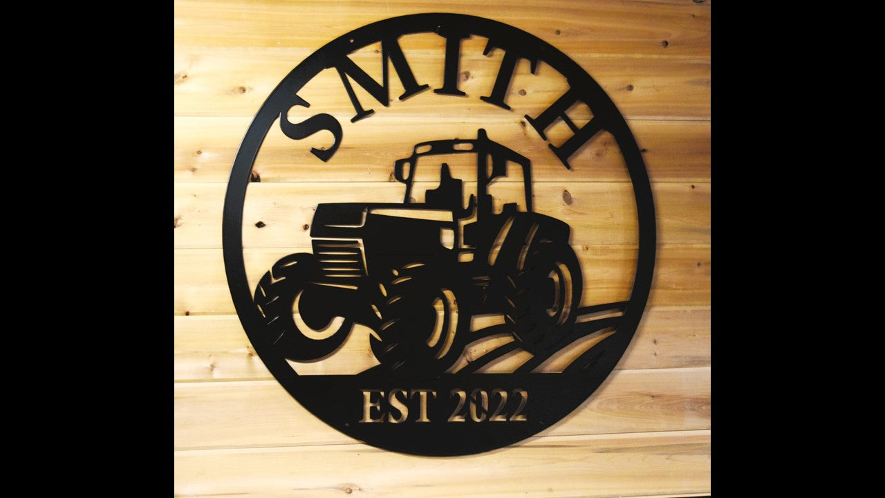 Black metal circle silhouette with a Tractor and field with the last name Smith on the top and EST 2022 on the bottom. Priced at 120 dollars.