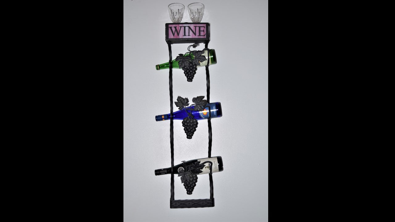 Custom black metal wine tree with grapes and vines holding 3 bottles of wine with 2 wine glasses displayed on top.